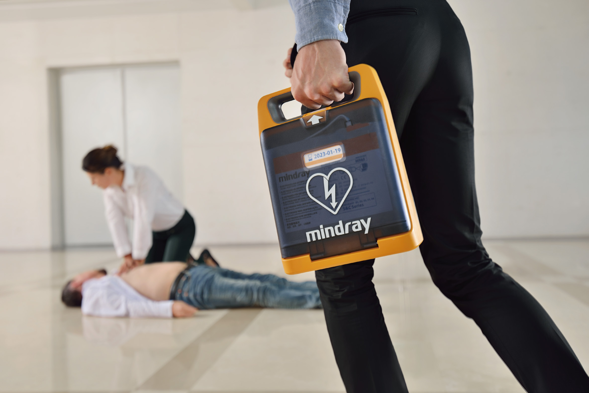 Mindray BeneHeart AED being carried during an emergency response